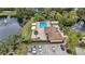 An elevated view of a community swimming pool, sundeck, and surrounding landscaping at 958 Sunridge Dr # H3, Sarasota, FL 34234