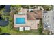 Overhead view of a community pool with lounge chairs and adjacent parking at 958 Sunridge Dr # H3, Sarasota, FL 34234