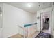 Upstairs hallway with teal railing and carpet at 958 Sunridge Dr # H3, Sarasota, FL 34234