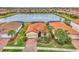 Community view showcasing a single-story house near a lake at 9895 Wingood Dr, Venice, FL 34292