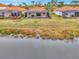 Aerial view showcasing lakefront location and community setting at 9895 Wingood Dr, Venice, FL 34292
