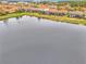 Aerial view showing multiple homes along lake, showcasing community at 9895 Wingood Dr, Venice, FL 34292