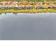 Aerial view of community lakefront homes with orange tile roofs at 9895 Wingood Dr, Venice, FL 34292