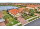 Single-story house with a red tile roof in a residential community at 9895 Wingood Dr, Venice, FL 34292