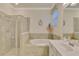 Spa-like bathroom with soaking tub and walk-in shower at 9895 Wingood Dr, Venice, FL 34292