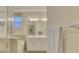 Double vanity bathroom with a large mirror and shower at 9895 Wingood Dr, Venice, FL 34292