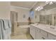 Bathroom with double vanity, soaking tub, and shower at 9895 Wingood Dr, Venice, FL 34292