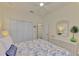 Bright bedroom with a queen-size bed and built-in wardrobe at 9895 Wingood Dr, Venice, FL 34292