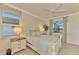 Bright bedroom with a queen-size bed and large window at 9895 Wingood Dr, Venice, FL 34292