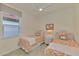 Twin bedroom with coral bedding and flamingo decor at 9895 Wingood Dr, Venice, FL 34292