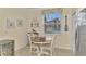 Small breakfast nook with white table and chairs, near kitchen at 9895 Wingood Dr, Venice, FL 34292