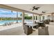 Covered patio overlooking pool with seating and tables at 9895 Wingood Dr, Venice, FL 34292