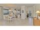 Bright dining area with white table and chairs, and a chandelier at 9895 Wingood Dr, Venice, FL 34292