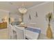 Bright and airy dining area with a white table and chairs at 9895 Wingood Dr, Venice, FL 34292