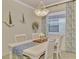 Charming dining area featuring a white table, and neutral decor at 9895 Wingood Dr, Venice, FL 34292