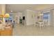 Casual dining area with white table and chairs, and view into the living room at 9895 Wingood Dr, Venice, FL 34292