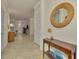 Open and inviting entryway with a decorative mirror and console table at 9895 Wingood Dr, Venice, FL 34292
