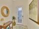 Light and spacious entryway with a console table and large artwork at 9895 Wingood Dr, Venice, FL 34292