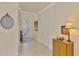 Bright and airy entryway with tile flooring and a console table at 9895 Wingood Dr, Venice, FL 34292