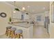 Modern kitchen featuring granite countertops and breakfast bar at 9895 Wingood Dr, Venice, FL 34292
