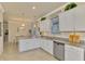 Spacious kitchen featuring white cabinets and granite countertops at 9895 Wingood Dr, Venice, FL 34292