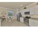 Bright kitchen with stainless steel appliances and white cabinets at 9895 Wingood Dr, Venice, FL 34292