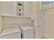 Laundry room with washer, dryer, and overhead storage at 9895 Wingood Dr, Venice, FL 34292