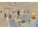 Comfortable living room featuring a sofa, chairs, and coffee table at 9895 Wingood Dr, Venice, FL 34292