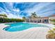Resort-style pool with lounge chairs and covered patio at 9895 Wingood Dr, Venice, FL 34292
