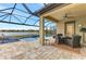 Relaxing pool area with covered patio and lake view at 9895 Wingood Dr, Venice, FL 34292