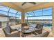 Covered patio with pool, seating area, and lake view at 9895 Wingood Dr, Venice, FL 34292