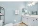 Bathroom with vanity, toilet, and shelving at 107 Corte Del Rosa, Venice, FL 34285