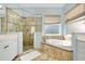 Spa-like bathroom with soaking tub, walk-in shower, and double vanity at 107 Corte Del Rosa, Venice, FL 34285