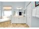 Bathroom with double vanity, soaking tub, and linen closet at 107 Corte Del Rosa, Venice, FL 34285