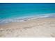 Scenic beach view with light blue water and sandy shore at 107 Corte Del Rosa, Venice, FL 34285