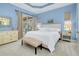 Bright bedroom with king-size bed, dresser, and sliding glass doors leading to a patio at 107 Corte Del Rosa, Venice, FL 34285