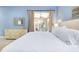 King-size bed, dresser, and sliding glass doors opening to a private patio at 107 Corte Del Rosa, Venice, FL 34285