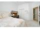 Spacious bedroom with a queen bed, built in desk and private bathroom access at 107 Corte Del Rosa, Venice, FL 34285