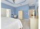 Spacious bedroom with king-size bed and access to bathroom at 107 Corte Del Rosa, Venice, FL 34285
