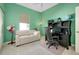 Home office with desk, couch and built-in shelving at 107 Corte Del Rosa, Venice, FL 34285