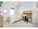 Bright bedroom with a comfortable bed, built-in desk, and ample closet space at 107 Corte Del Rosa, Venice, FL 34285