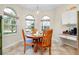 Breakfast nook with wood table and chairs, and coffee bar area at 107 Corte Del Rosa, Venice, FL 34285