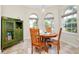 Bright breakfast nook features wood table and chairs, and built-in cabinetry at 107 Corte Del Rosa, Venice, FL 34285