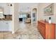 Bright and airy entryway with tile flooring and wood console table at 107 Corte Del Rosa, Venice, FL 34285