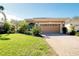 House with a two-car garage and a brick driveway at 107 Corte Del Rosa, Venice, FL 34285