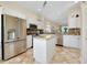 Modern kitchen with stainless steel appliances and granite island at 107 Corte Del Rosa, Venice, FL 34285