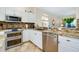 Spacious kitchen with granite countertops and stainless steel appliances at 107 Corte Del Rosa, Venice, FL 34285