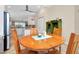Open kitchen with stainless steel appliances and island at 107 Corte Del Rosa, Venice, FL 34285