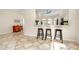 Eat-in kitchen with granite counters, stainless steel appliances, and breakfast bar at 107 Corte Del Rosa, Venice, FL 34285