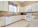 Fully equipped community kitchen with white cabinets at 107 Corte Del Rosa, Venice, FL 34285